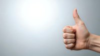 Hand showing thumbs up gesture against clean white background for positive feedback and approval concepts in business presentations.