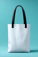 White tote bag with black handles on turquoise background, isolated for mockup use in retail, branding, and eco-friendly shopping promotions.