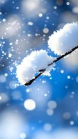 Fresh snow accumulated on dark tree branch against vibrant blue winter sky with falling snowflakes and bokeh light effects creating magical seasonal atmosphere.