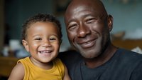 African American father and young son smiling together indoors, displaying warmth and joy in their family bond and relationship.