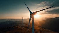 Wind turbines on rolling hills at sunset with golden sunlight creating dramatic silhouettes against cloudy sky, showcasing renewable energy landscape.