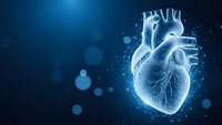 Digital holographic human heart with glowing blue light effects and particles on dark background for medical technology presentations.