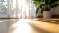 Warm sunlight streaming through sheer curtains casting long shadows on wooden floor, with blurred houseplant in soft focus background creating cozy morning atmosphere.