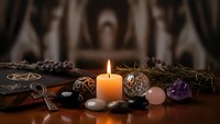 Mystical altar setup with burning candle, crystals, tarot cards and natural elements for spiritual practices and meditation rituals.