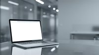 Open laptop with blank white screen on desk in modern blurred office environment for business presentations and digital workspace mockups.
