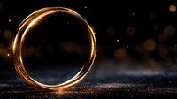 Glowing golden ring with magical light trail effect on dark background with bokeh particles and sparkles, creating mystical atmosphere.