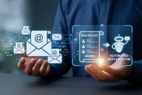 Professional businessman holding digital email marketing automation system with mailing list and automated reply icons floating above hands.