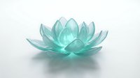 Translucent turquoise lotus flower with layered petals isolated on white background, suitable for wellness, spa, meditation, and design projects.
