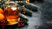 Glass jar of golden honey with orange citrus fruits, red winter berries and pine branches on dark rustic background. Seasonal natural food composition.