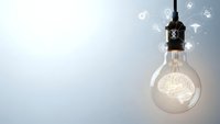 Light bulb with glowing brain filament surrounded by floating innovation icons representing creative thinking, ideas, and intellectual concepts.