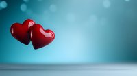 Red glossy hearts floating against turquoise bokeh background. Romantic minimalist composition with copy space for Valentine's day cards, wedding invitations and love messages.