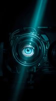 Futuristic camera lens with blue eye visible through center, glowing cyan light rays, dark background, technology and vision concept for filmmaking and digital media projects.