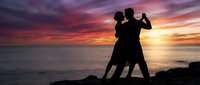 Romantic couple dancing tango silhouette against dramatic sunset sky over ocean. Perfect for wedding invitations, romance themes, dance studios.