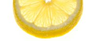 Fresh lemon slice with vibrant yellow color and translucent flesh, isolated on white background, suitable for food and beverage design projects.