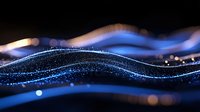 Glowing blue wave of particles flowing on dark background with light bokeh effect and sparkles creating dynamic motion and energy visualization.