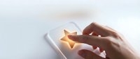 Close-up of hand holding smartphone with glowing star icon on screen, representing mobile app rating, customer feedback, and digital service quality assessment.