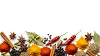 Colorful spices and herbs arranged on white background with paprika, turmeric, cinnamon, star anise, bay leaves, chili peppers and peppercorns.