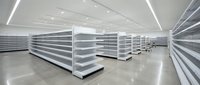 Empty retail shelving units with fluorescent ceiling lights in a modern supermarket or store interior with polished concrete flooring, suitable for commerce and retail design projects.