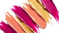 Colorful makeup brush strokes in pink coral and gold tones on white background for cosmetic beauty and fashion design projects.