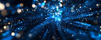 Abstract blue light burst with sparkling particles and bokeh effects creating dynamic energy rays radiating from center on dark background for digital art.