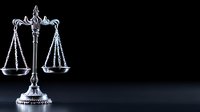 Silver scales of justice on dark background, symbol of law, legal system and equality. Professional metallic balance isolated with dramatic lighting and copy space.