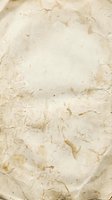 Aged parchment paper texture with natural brown stains and weathered edges for vintage design projects and historical document backgrounds.