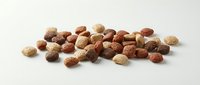 Mixed nuts and legumes scattered on white background isolated for healthy snacking and cooking ingredients display.