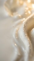 Luxurious golden silk fabric with water droplets creating elegant texture and soft bokeh lighting for premium fashion and beauty concepts.