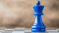 Blue queen chess piece standing on chessboard against blurred background, strategic game concept for business and leadership decisions.