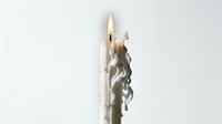 Burning white taper candle with melting wax drips on a light background, evoking atmosphere, romance, and mindfulness concepts.