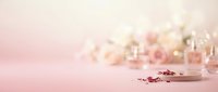 Luxury cosmetic bottles and perfume containers arranged on soft pink background with scattered glitter and bokeh lights, suitable for beauty and skincare marketing.