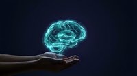 Human hand presenting glowing turquoise brain hologram against dark background symbolizing artificial intelligence, neuroscience and mental health concepts.