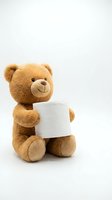 Cute brown teddy bear holding blank white paper card on isolated background for greeting cards, invitations and promotional materials.