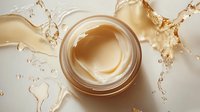 Luxurious golden skincare cream jar with dynamic splash effects and droplets creating elegant beauty product composition for cosmetic advertising.