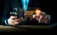 Businessman touching glowing shopping cart icon with e-commerce symbols on digital interface for online retail and mobile commerce applications.