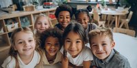 Diverse group of happy elementary school children smiling together in classroom environment, representing friendship, education, and childhood joy.