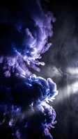 Dramatic purple and blue smoke clouds swirling against dark background creating abstract atmospheric effects for creative projects and artistic designs.