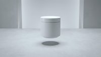 White cosmetic jar container floating above marble surface in minimalist studio setting for skincare product packaging and branding applications.