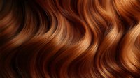 Luxurious wavy auburn hair with golden highlights flowing in smooth curves, showcasing natural shine and healthy texture. Perfect for beauty and haircare advertising.
