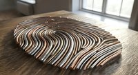 Wooden fingerprint sculpture on table showcasing unique biometric identity pattern for security and forensic concepts in modern interior setting.