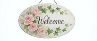 Welcome sign with pink roses and ivy leaves, hanging oval wooden plaque for home decor and entryway greeting.