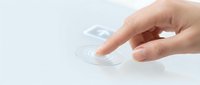 Hand placing contact lens on fingertip against clean white background, vision correction and eye care concept for optical health applications.