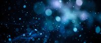 Abstract blue bokeh lights and particles floating in dark space creating dreamy atmospheric background for digital design and creative projects.