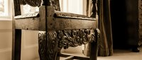 Ornate antique wooden chest with intricate carved details and decorative legs in elegant interior setting for luxury home decor and vintage furniture design.