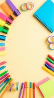 Colorful markers, highlighters, adhesive tape rolls, and spiral notebook arranged on cream background with copy space for creative projects, back to school supplies, or stationery design layouts.