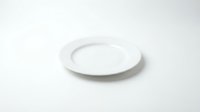 Empty white ceramic plate on clean white background isolated for kitchen dining restaurant menu design mockup presentations.