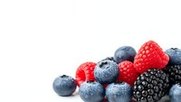 Fresh mixed berries including blueberries, raspberries and blackberries isolated on white background for healthy eating and nutrition concepts.