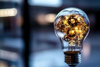 Light bulb filled with golden gears and cogs representing innovation, creativity, and mechanical thinking in business and technology concepts.