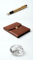 Luxury business accessories collection featuring golden fountain pen, leather portfolio and crystal diamond on white background for corporate branding.