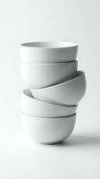 Stack of white ceramic bowls arranged in tilted formation against neutral background, suitable for kitchenware, tableware, and home decor design projects.